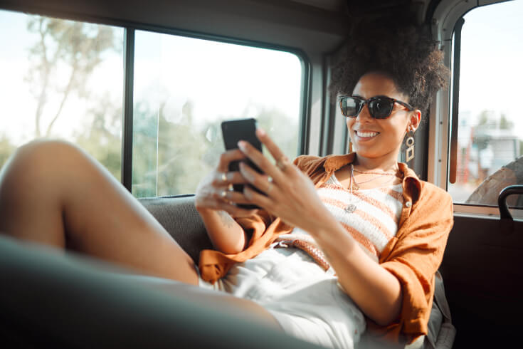 An image of a person checking their phone inside a vehicle.