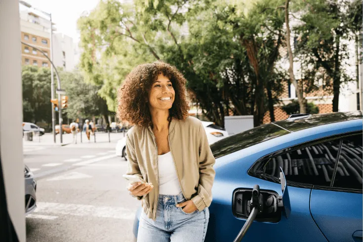 Image of driver smiling while electric car charges