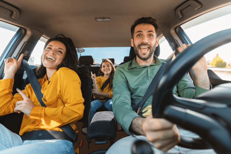 Car interior view of family having fun