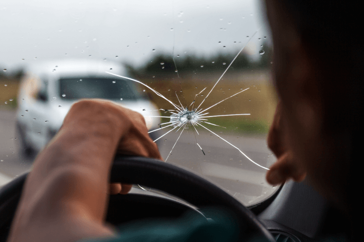 Image of person driving with cracked windshield.