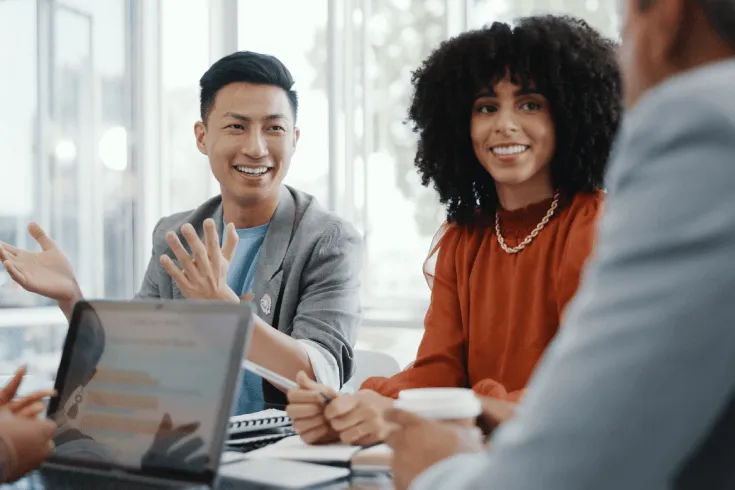 A multicultural group of young colleagues collaborate on a project.