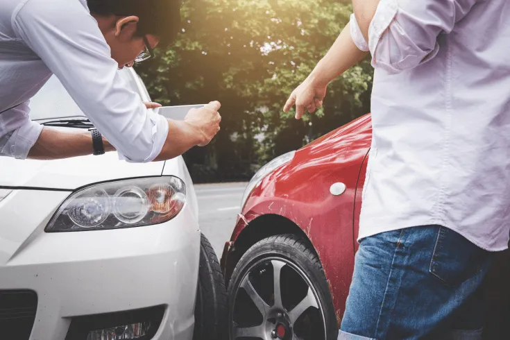 Person taking photo of a car collision