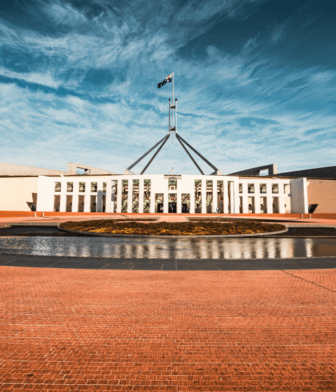Mobile version of an image of Canberra parliament house, with Australian flag flying.