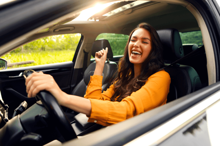 Happy person driving car with eyes closed