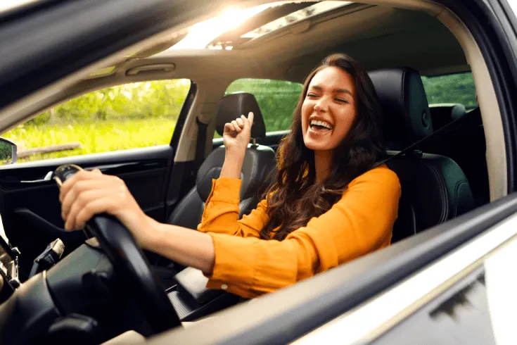 Happy person driving car with eyes closed