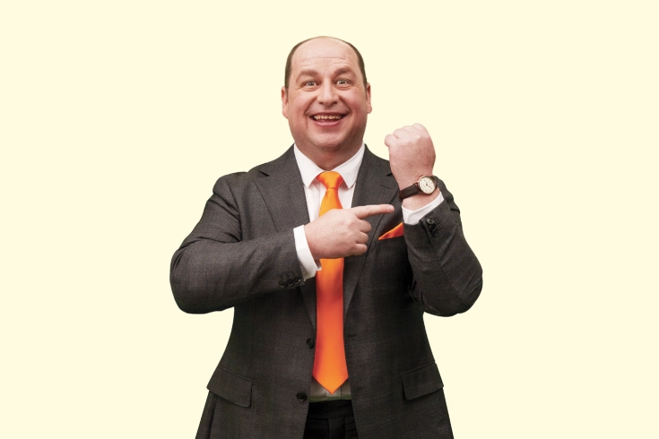 Mr iSelect pointing at his watch