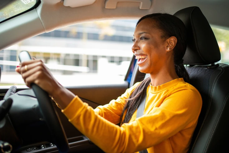 Image of a lady driving a car
