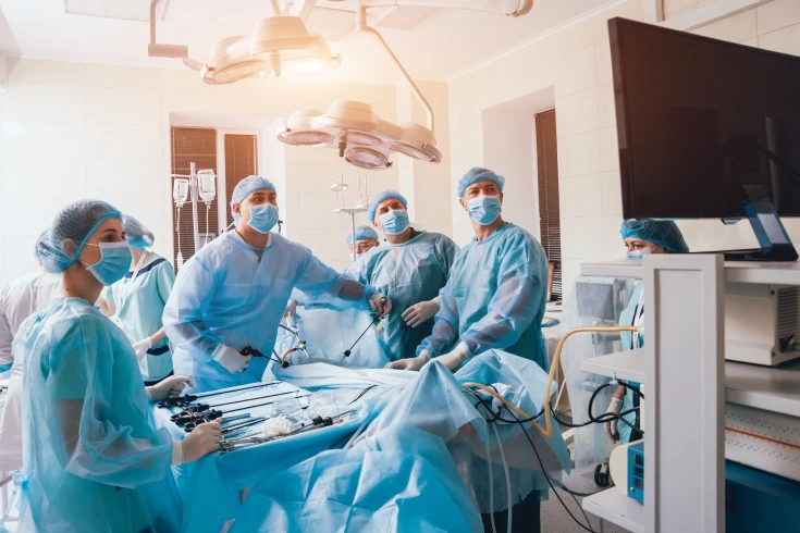 A team of doctors perform a laparoscopy on a patient in hospital