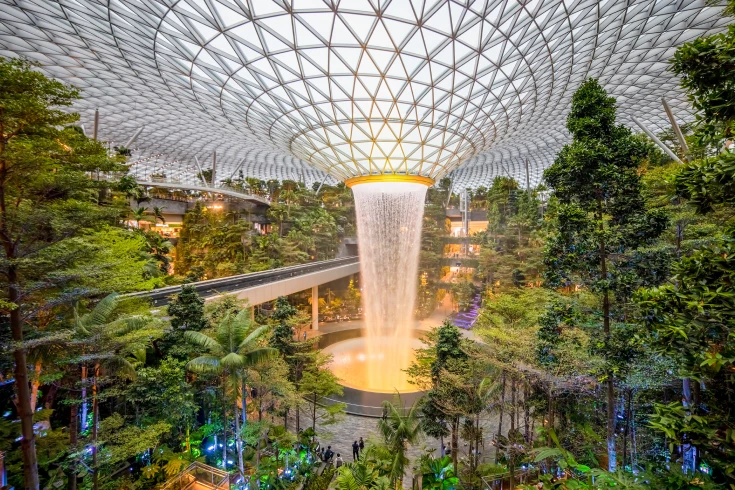 Interior of Gardens by the Bay with the centre waterfall from the roof and lush plants surrounding it