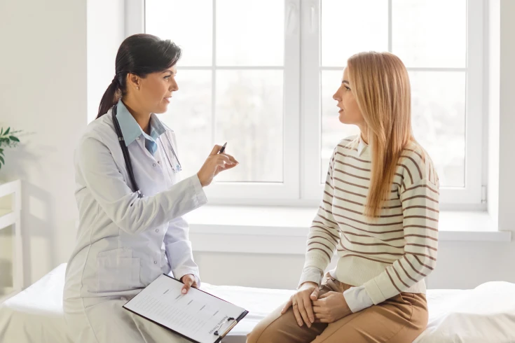 A doctor speaks with a patient about tubal ligation