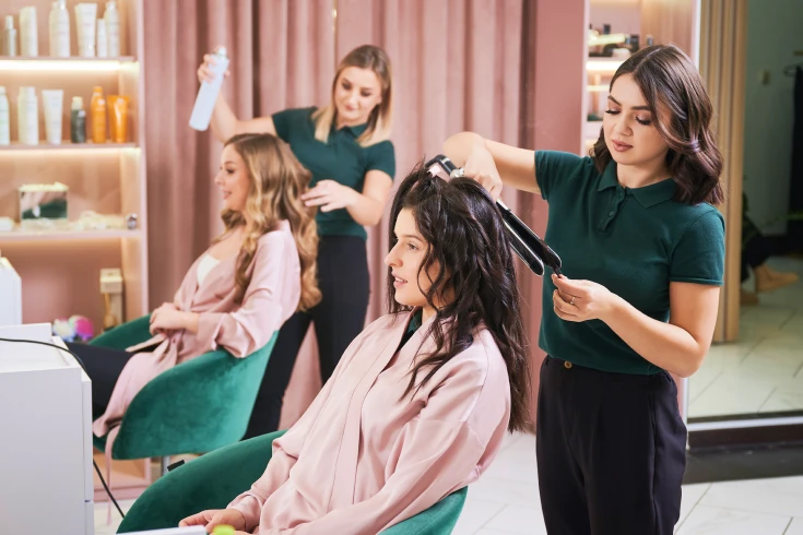 An image of a two women getting their hair done in a salon