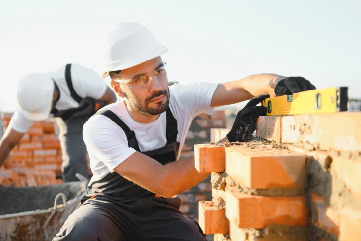 An image of a bricklayer using a spirit level