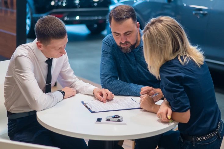 A couple discussing agreed vs market value cover with an insurance agent