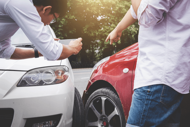 Person taking photo of a car collision