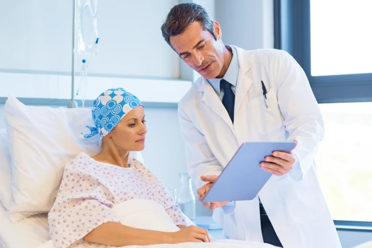A doctor speaks with a chemotherapy patient about their treatment