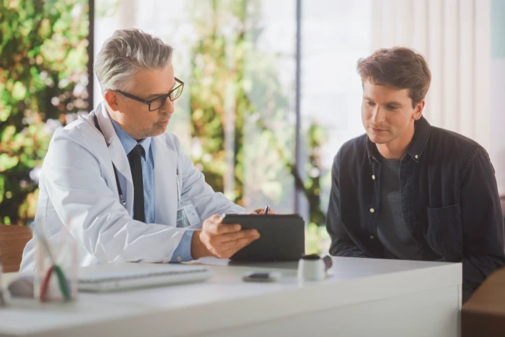 A doctor discusses a vasectomy procedure with a patient
