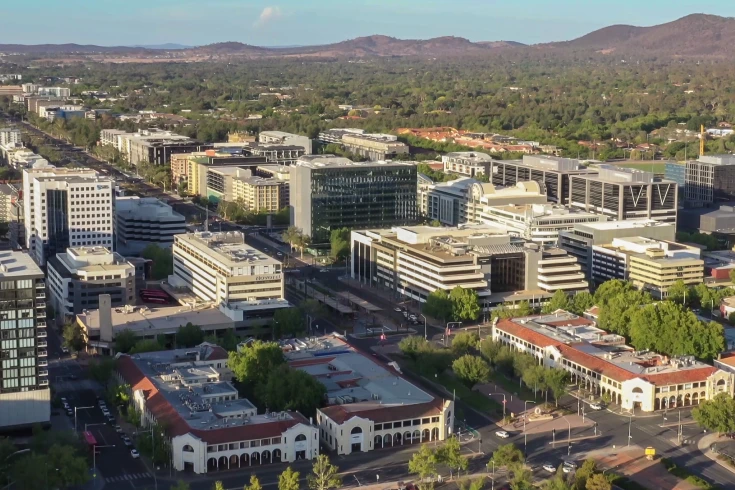 Aerial shot of a business district with mountains in the background
