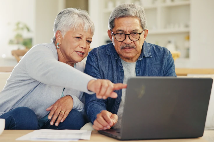 A couple compare health insurance policies to see if they can save on their cover