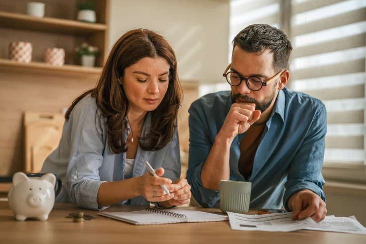 A couple calculating car running costs